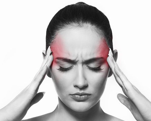 Woman holding her temples, migraine or headache